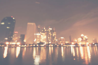 Illuminated buildings against sky at night