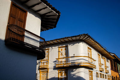 Low angle view of building against clear blue sky