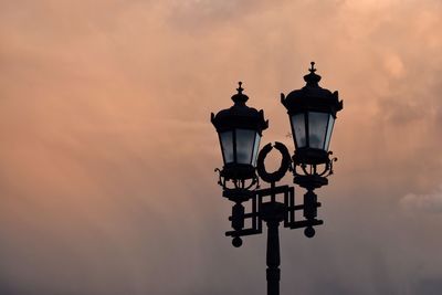 Low angle view of street lamp against sky during sunset