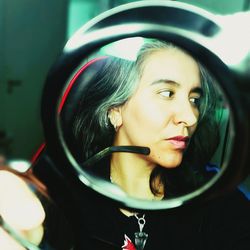 Close-up of young woman in car, woman through the lens, circle, perspective, half profile