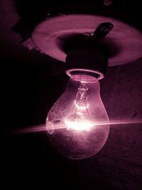 Close-up of light bulb at night