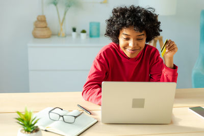 Portrait of boy using laptop at home