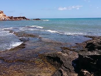 Scenic view of sea against blue sky