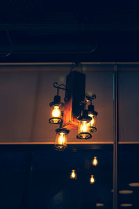 Low angle view of illuminated lights on ceiling