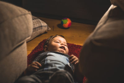 Close-up of boy sleeping on sofa at home