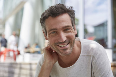 Portrait of smiling man at an outdoor cafe