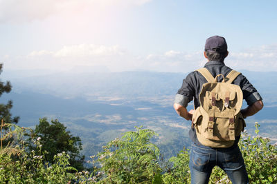 Man standing on mountain against sky