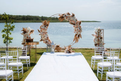 Wedding ceremony area with a round arch of dried flowers