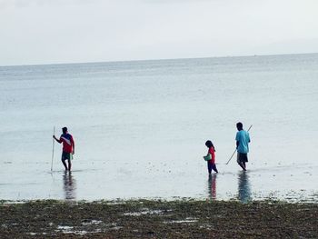 People on beach against sky