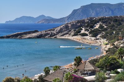 High angle view of sea and mountains against sky