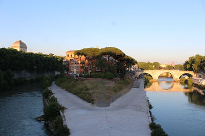 Arch bridge over river against sky