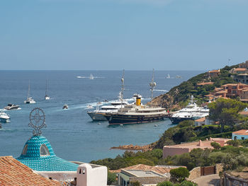 Sailboats in sea against clear sky