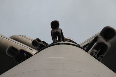 Low angle view of people against sky