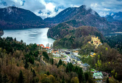 High angle view of townscape by mountains against sky