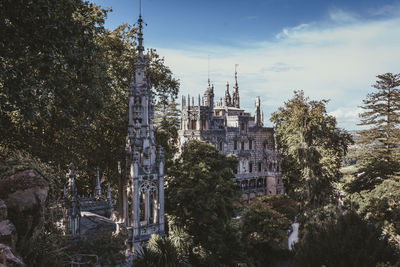 Panoramic view of trees and buildings against sky