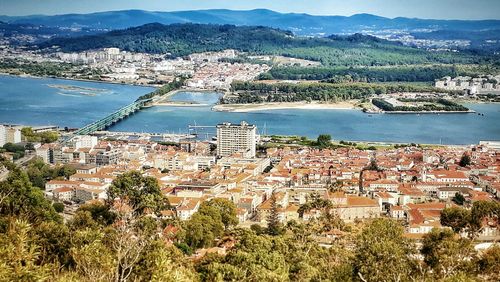 High angle view of river and town against sky