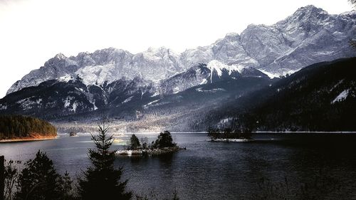 Scenic view of lake and mountains against sky