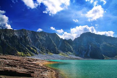 Scenic view of mountains against cloudy sky