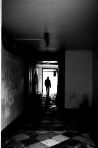 Rear view of man standing in corridor