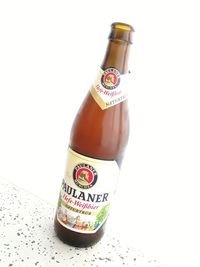 Close-up of beer bottle against white background