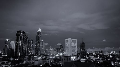 Panoramic view of illuminated buildings against sky at night