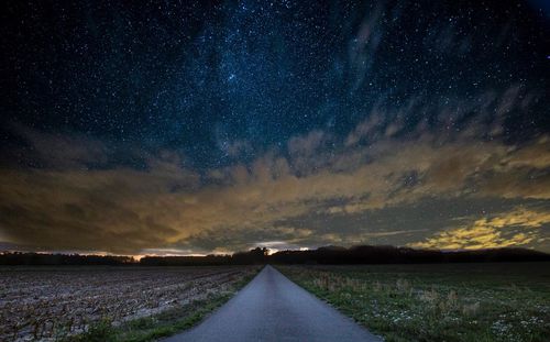 Scenic view of road against sky at night