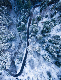 High angle view of snow covered mountain by river