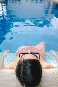 Rear view of woman at swimming pool