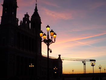 Low angle view of built structure against sky at sunset