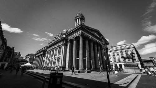 Low angle view of building against cloudy sky