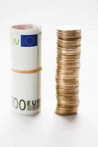 Stack of coins with banknote