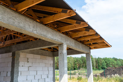 Roof trusses covered with a membrane on a detached house under construction, visible roof 