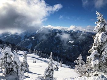 Scenic view of snow covered mountains against sky