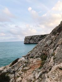 Scenic view of sea and rock formations against sky