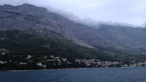 Scenic view of mountains against cloudy sky