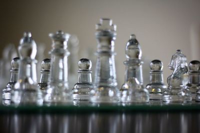 Close-up of glass chess on table