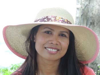 Portrait of smiling woman wearing sun hat