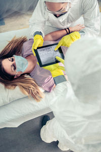 Doctor examining patient using digital tablet