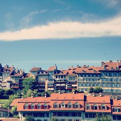 Residential buildings against cloudy sky