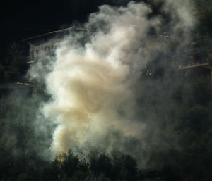 Low angle view of smoke emitting from sky at night