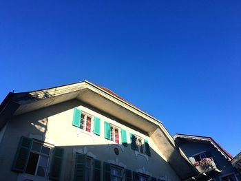 Low angle view of building against clear blue sky