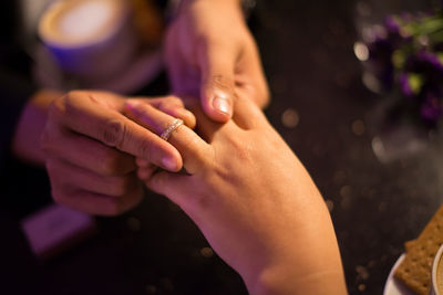 Close-up of couple with engagement ring