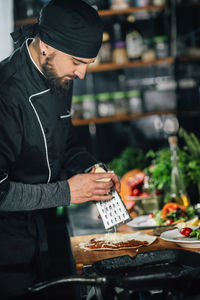 Male chef preparing food on table