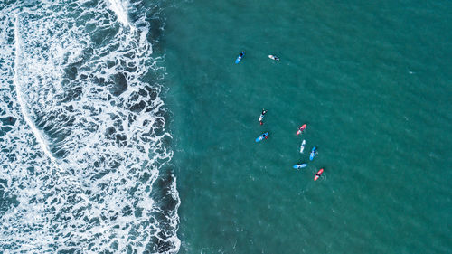 Group of surfers waiting to surf a wave