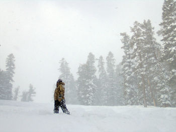 Person standing on snow covered field