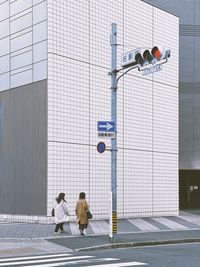 People on street against buildings in city