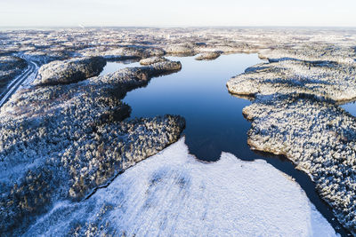 Aerial view of snowy landscape with lake