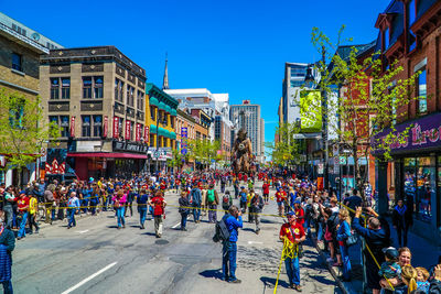 People on street against blue sky