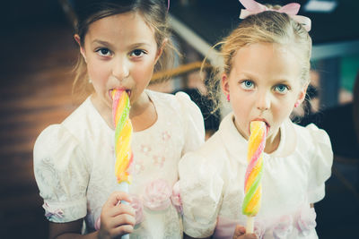 Close-up of happy girl eating ice cream at night