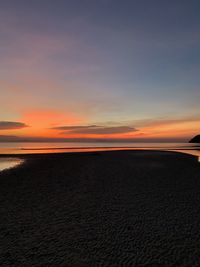 Scenic view of beach against sky during sunset
